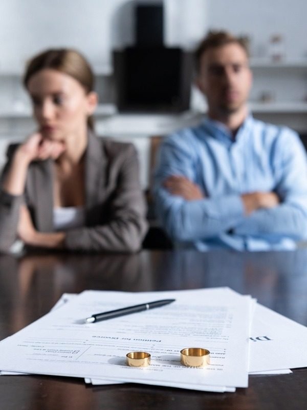 Divorce documents with wedding rings, divorce problem solution by astrologer Devraj Sharma
