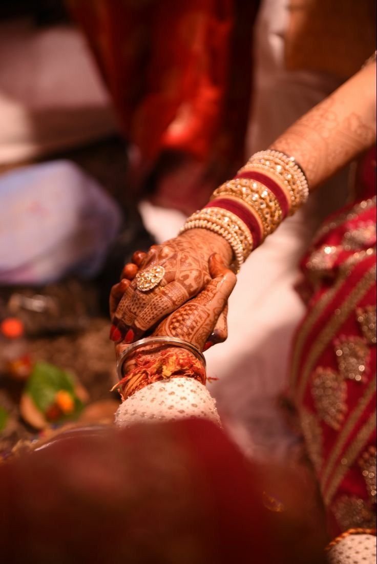Indian wedding hands with mehndi and bangles, intercaste marriage problem solution by astrologer Devraj Sharma
